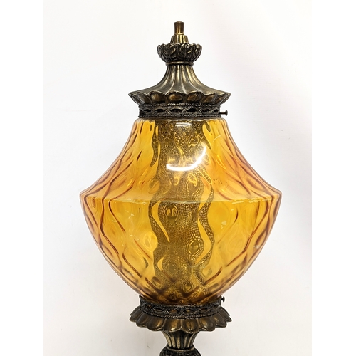 294 - A tall vintage amber glass and brass paraffin lamp. 78cm