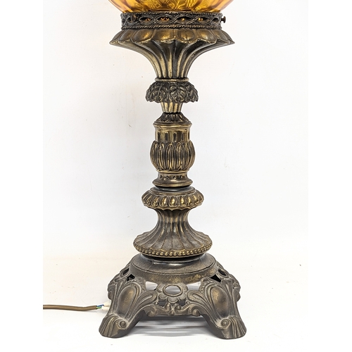 294 - A tall vintage amber glass and brass paraffin lamp. 78cm