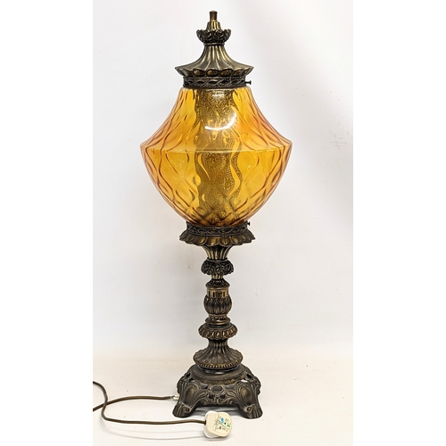 294 - A tall vintage amber glass and brass paraffin lamp. 78cm