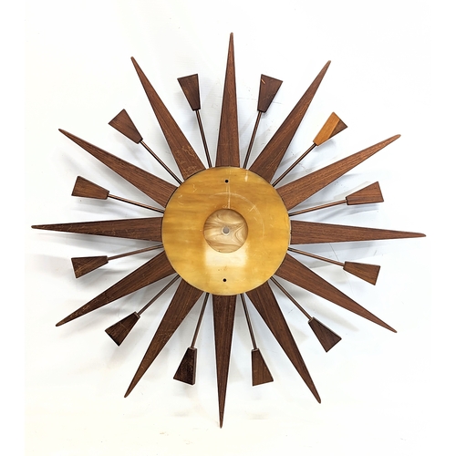 150 - A Mid Century teak sunburst clock, no works. 60cm