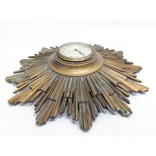 152 - A 1930s brass sunburst wall clock.  40cm