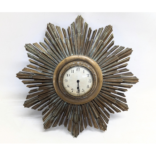 152 - A 1930s brass sunburst wall clock.  40cm