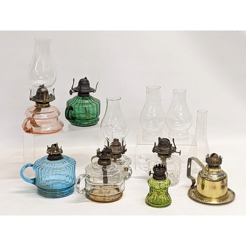 185 - A quantity of Victorian finger oil lamps.