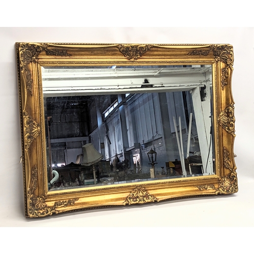 167 - A large gilt framed bevelled mirror. 111.5x81cm