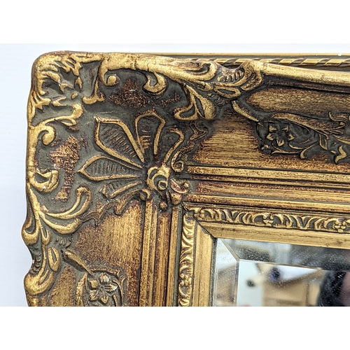 167 - A large gilt framed bevelled mirror. 111.5x81cm