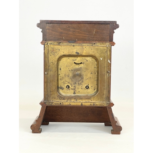 163 - A late 19th century mahogany and brass cased mantle clock with cherub and enamel face. 24x11x30cm