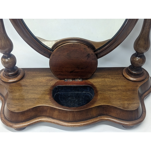 287 - A Victorian mahogany dressing mirror. 65x26x63cm