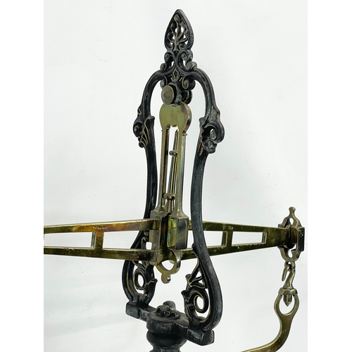 159 - A set of large Victorian brass and cast iron Class B balance scales with weights. 65x83cm