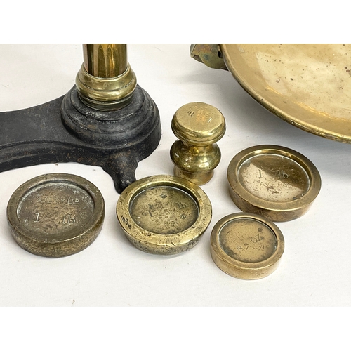 159 - A set of large Victorian brass and cast iron Class B balance scales with weights. 65x83cm