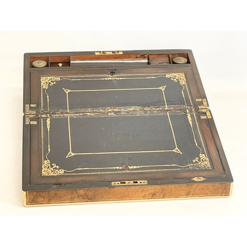 36 - A good quality early Victorian Walnut brass bound writing slope. 45.5x25x17.5cm closed.