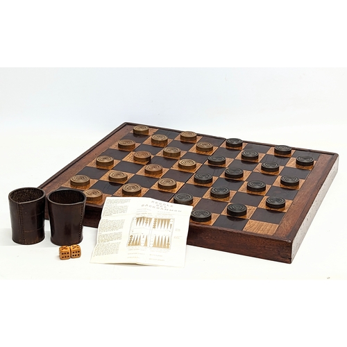 165 - An early 20th century mahogany draughts board with pieces. Board measures 51.5x45.5cm