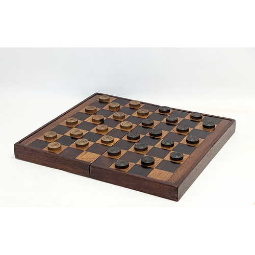 165 - An early 20th century mahogany draughts board with pieces. Board measures 51.5x45.5cm