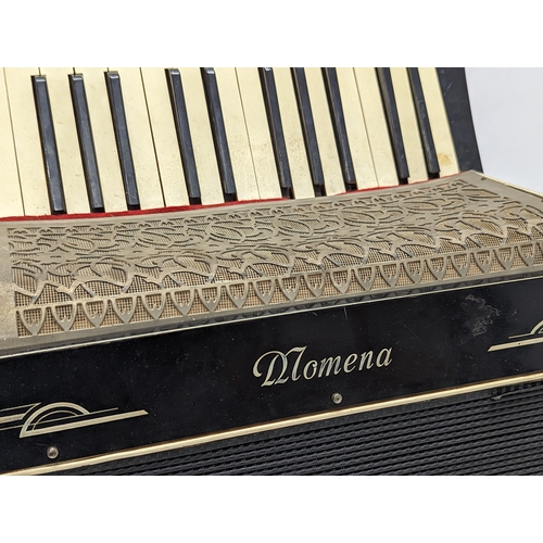 183 - A vintage Momena accordion in case.