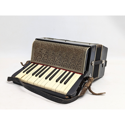 183 - A vintage Momena accordion in case.