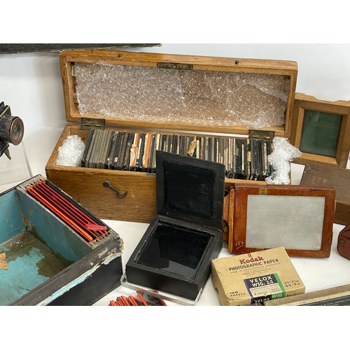 102 - A collection of early 20th century camera lantern plates and The Standard Magic Lantern in box.