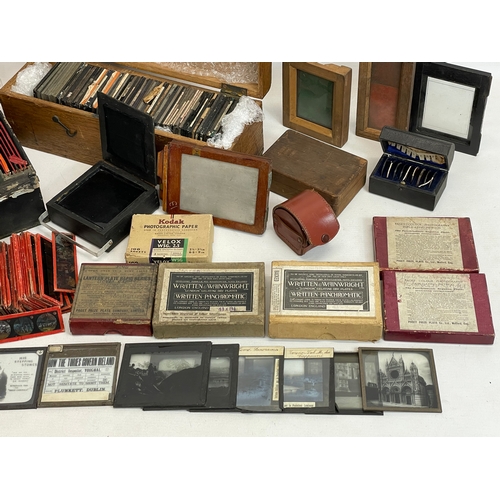 102 - A collection of early 20th century camera lantern plates and The Standard Magic Lantern in box.