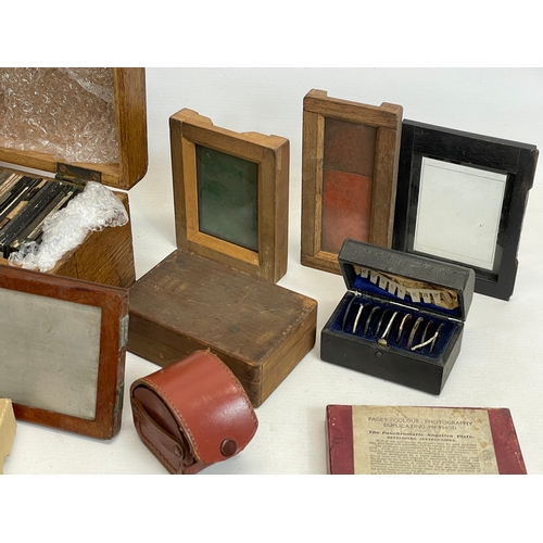 102 - A collection of early 20th century camera lantern plates and The Standard Magic Lantern in box.