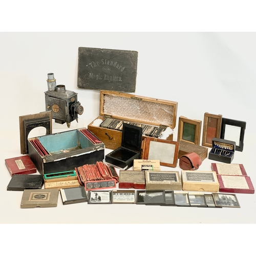 102 - A collection of early 20th century camera lantern plates and The Standard Magic Lantern in box.