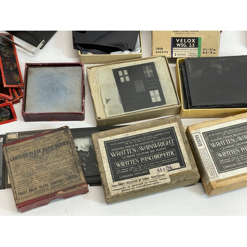 102 - A collection of early 20th century camera lantern plates and The Standard Magic Lantern in box.