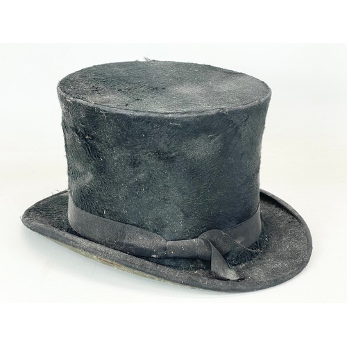 175 - A Christy’s of London top hat with an early 20th century wall stand.