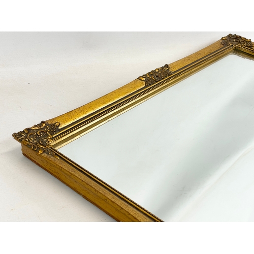 116 - An ornate gilt framed mirror. 45x55cm