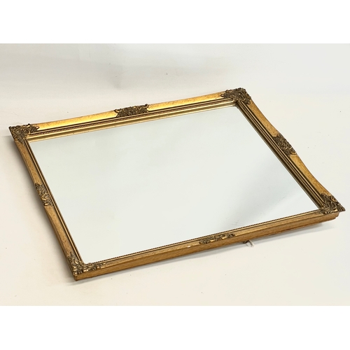 116 - An ornate gilt framed mirror. 45x55cm