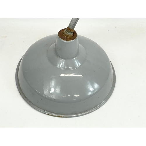 123 - A vintage industrial light fitting. 36x64cm