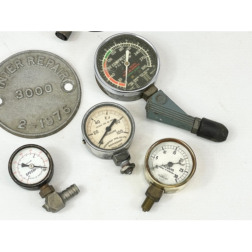 127 - A quantity of vintage gauges and brass signs.