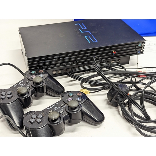 260A - A Sony PlayStation 2 game console with 2 controllers, leads / cables, and memory card.