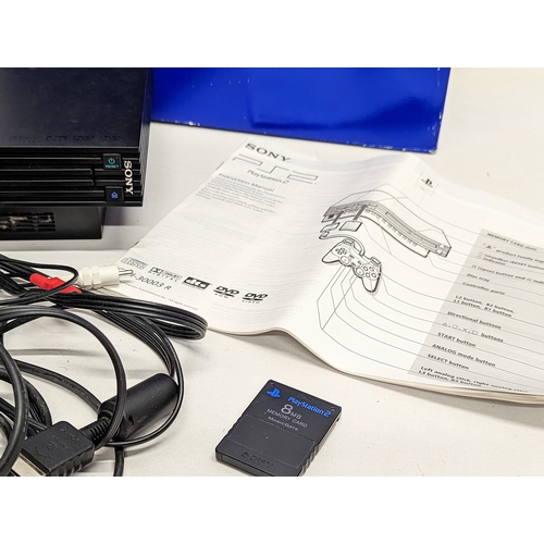 260A - A Sony PlayStation 2 game console with 2 controllers, leads / cables, and memory card.