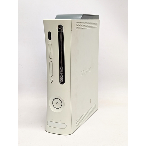 260B - An XBox 360 game console with 4 controllers, leads / cables, etc.