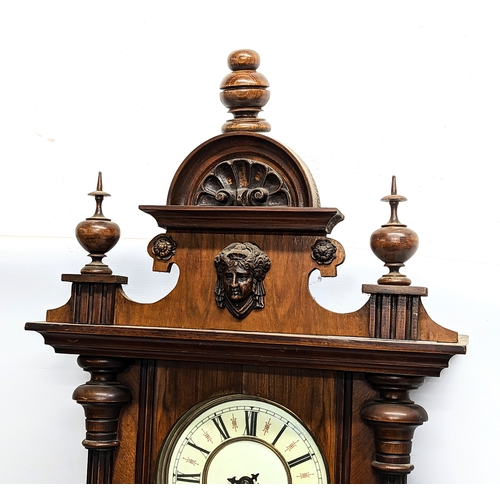 45 - A large Victorian mahogany Vienna wall clock with pendulum and key. 124cm