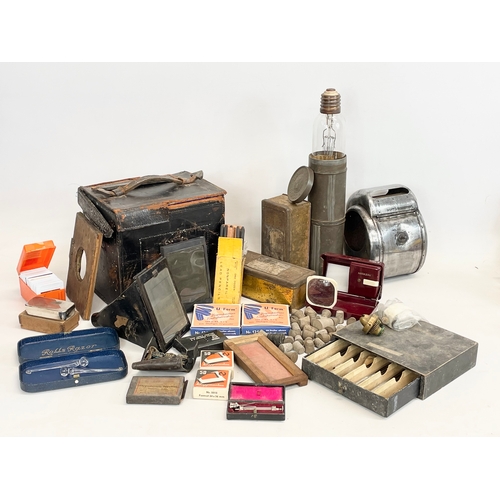 260Q - A sundry lot. Including vintage camera equipment, a Bournville Cocoa tin, old pharmacy equipment etc... 