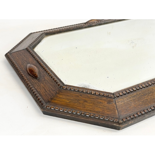 290A - A 1920’s oak framed mirror. 48x68cm