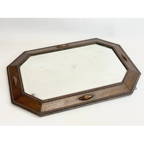 290A - A 1920’s oak framed mirror. 48x68cm