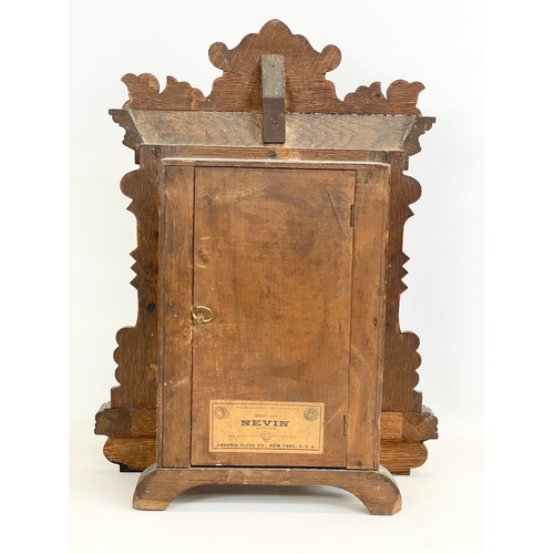 270A - A late 19th century American oak cased Eight Day Nevin Strike mantle clock by Ansonia. With key and ... 