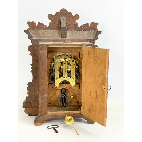 270A - A late 19th century American oak cased Eight Day Nevin Strike mantle clock by Ansonia. With key and ... 