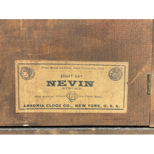 270A - A late 19th century American oak cased Eight Day Nevin Strike mantle clock by Ansonia. With key and ... 