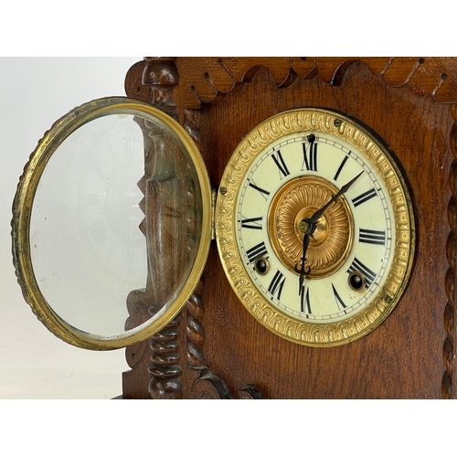 270A - A late 19th century American oak cased Eight Day Nevin Strike mantle clock by Ansonia. With key and ... 