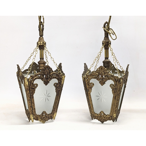 52 - A pair of vintage ornate brass light fittings with glass panels. 57cm including chain.