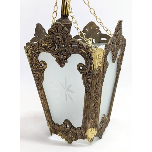 52 - A pair of vintage ornate brass light fittings with glass panels. 57cm including chain.