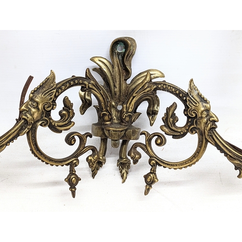 53 - A pair of early 20th century brass wall sconces.