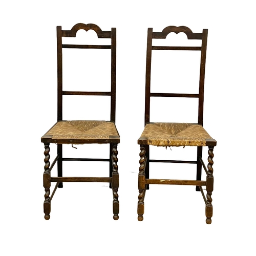 95 - A pair of 1920’s oak side chairs on rush seats.