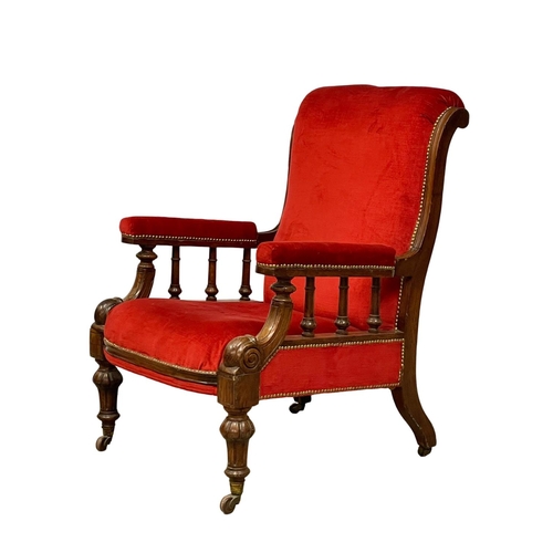 953 - A large Victorian oak framed gents armchair on brass cup casters. Circa 1870.