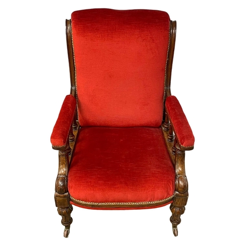 953 - A large Victorian oak framed gents armchair on brass cup casters. Circa 1870.