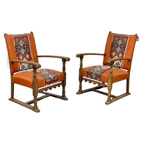 96 - A pair of early 20th century oak armchairs with carpetbag upholstery. Circa 1920.