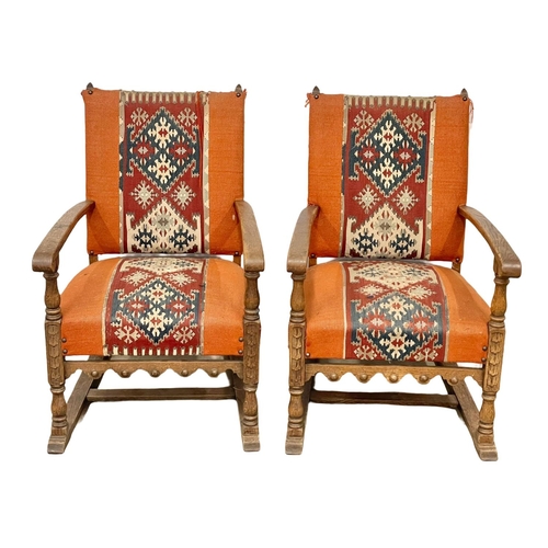 96 - A pair of early 20th century oak armchairs with carpetbag upholstery. Circa 1920.