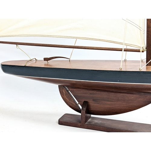 54 - A large vintage wooden yacht on stand. 96x92cm