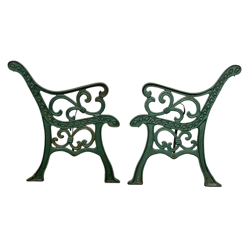 121 - A pair of large cast iron garden bench ends. 64x76cm