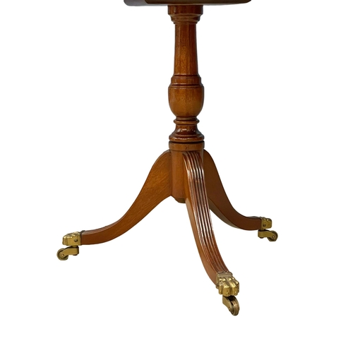 122I - An inlaid mahogany pedestal end table on brass paw feet. 53.5x49cm